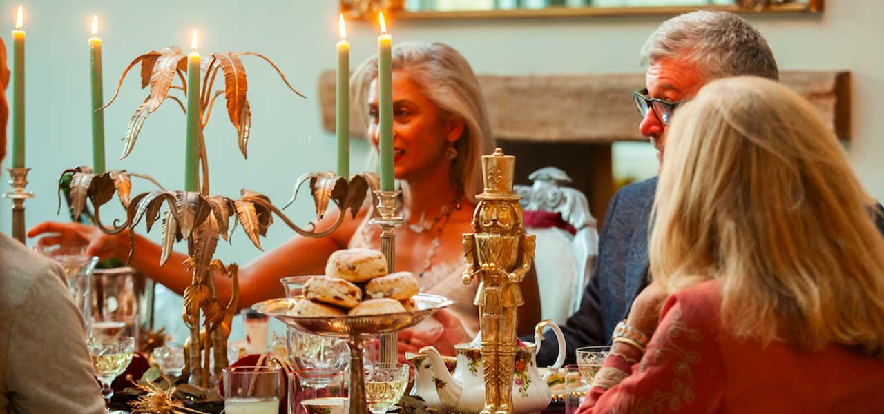 Guests enjoying a candlelit Christmas afternoon tea at Heritage House in the Cotswolds