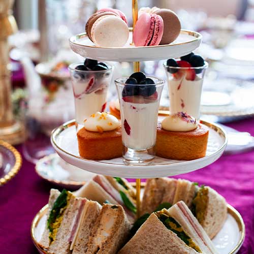 Heritage-House-Antiques-Tour-Feature-images-afternoon-tea--cotswolds-antiques Tiered afternoon tea stand with finger sandwiches, cakes and macarons at Heritage House, Cotswolds